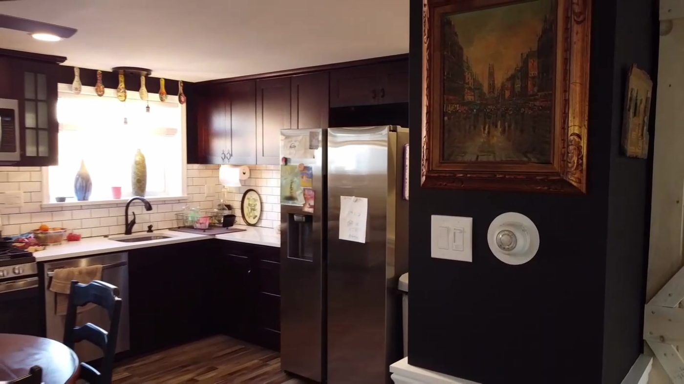Kitchen with dark cabinets and subway tile